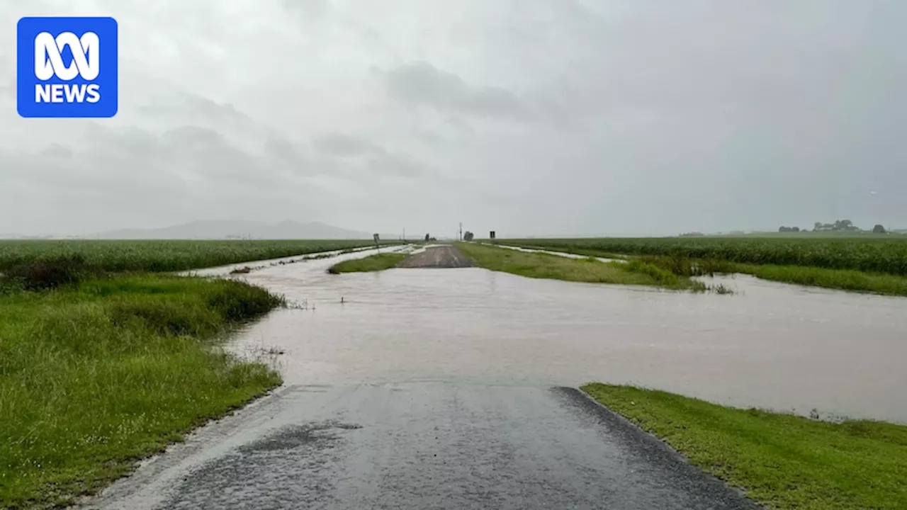 Two rescued as Townsville's flooding rains head south towards Whitsundays, Mackay