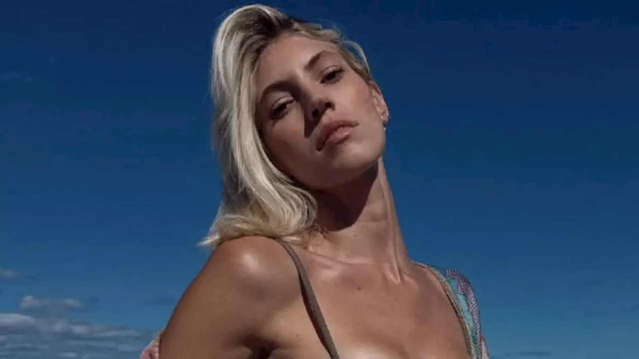 Devon Windsor shows off her size ZERO body in a bikini while showering on a beach