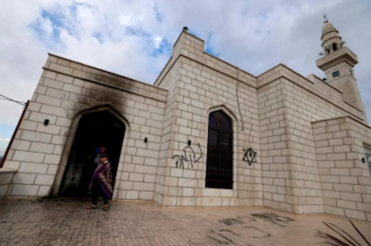 Palestinians accuse Israeli settlers of arson and hate slogans spray-painted on walls at West Bank mosque