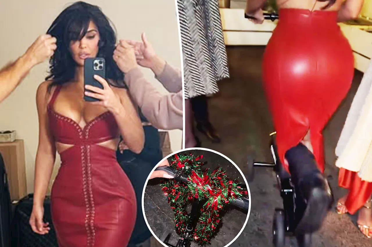 Kim Kardashian gets festive in lace-up leather dress and tinsel-wrapped scooter after breaking her foot