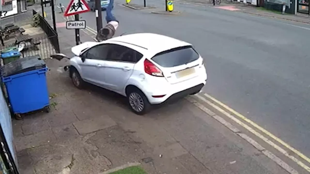 Amazing moment pedestrian leaps into the air to avoid full impact when Ford Fiesta mounts pavement -...