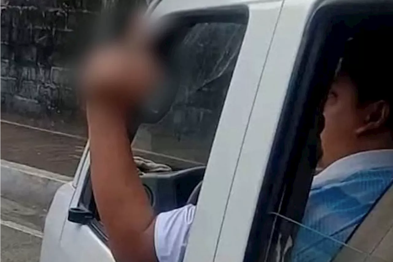 Driver of van bearing mayor's face sticks dirty finger up at motorist