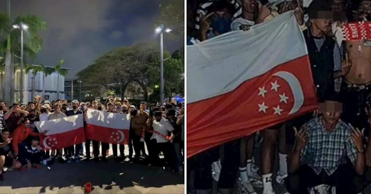 Malaysian Football Fans Pose With Upside-Down Singapore Flags