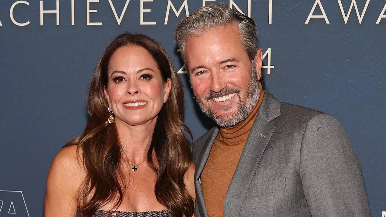 Brooke Burke, 53, sizzles in a see-through gown as she snuggles up to her fiance at NYC event