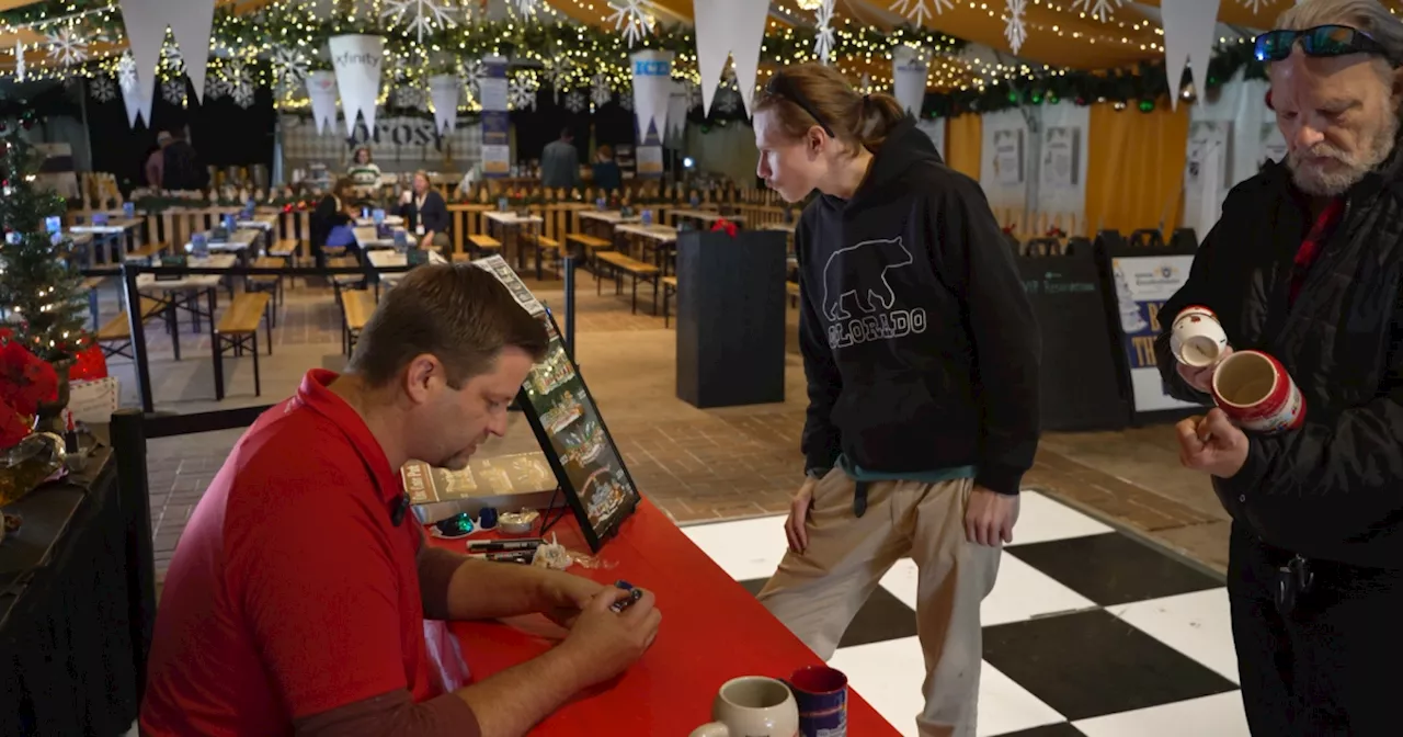 Denver Christkindlmarket illustrator signs 2024 mugs for collectors before supply runs out