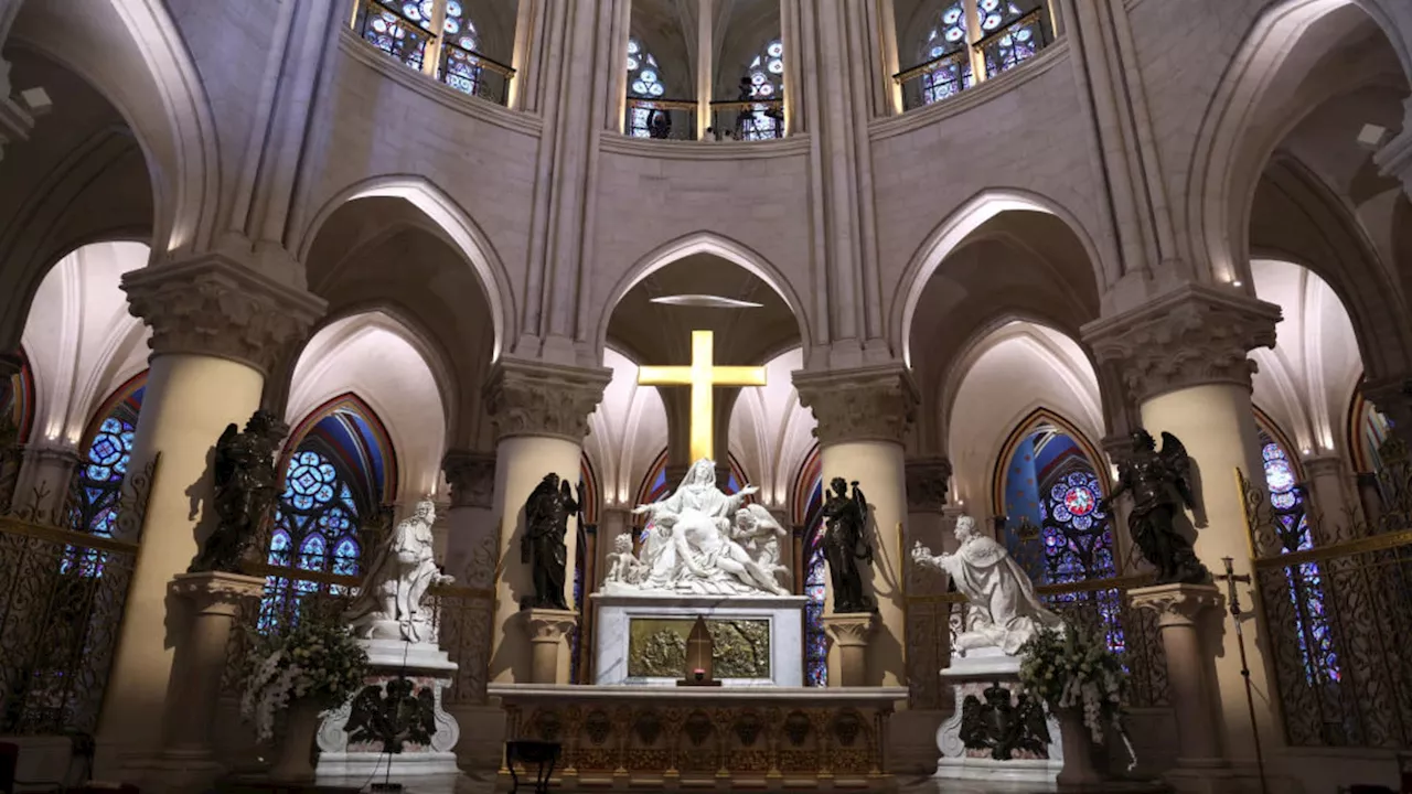 An archbishop's knock formally restores Notre Dame to life as winds howl and heads of state look on