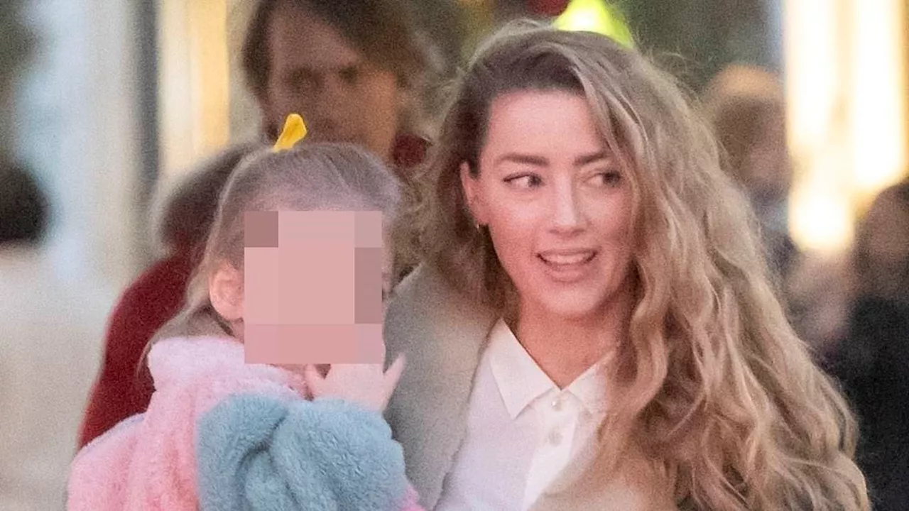 Amber Heard takes daughter Oonagh, three, for a stroll in Madrid after announcing she is expecting...