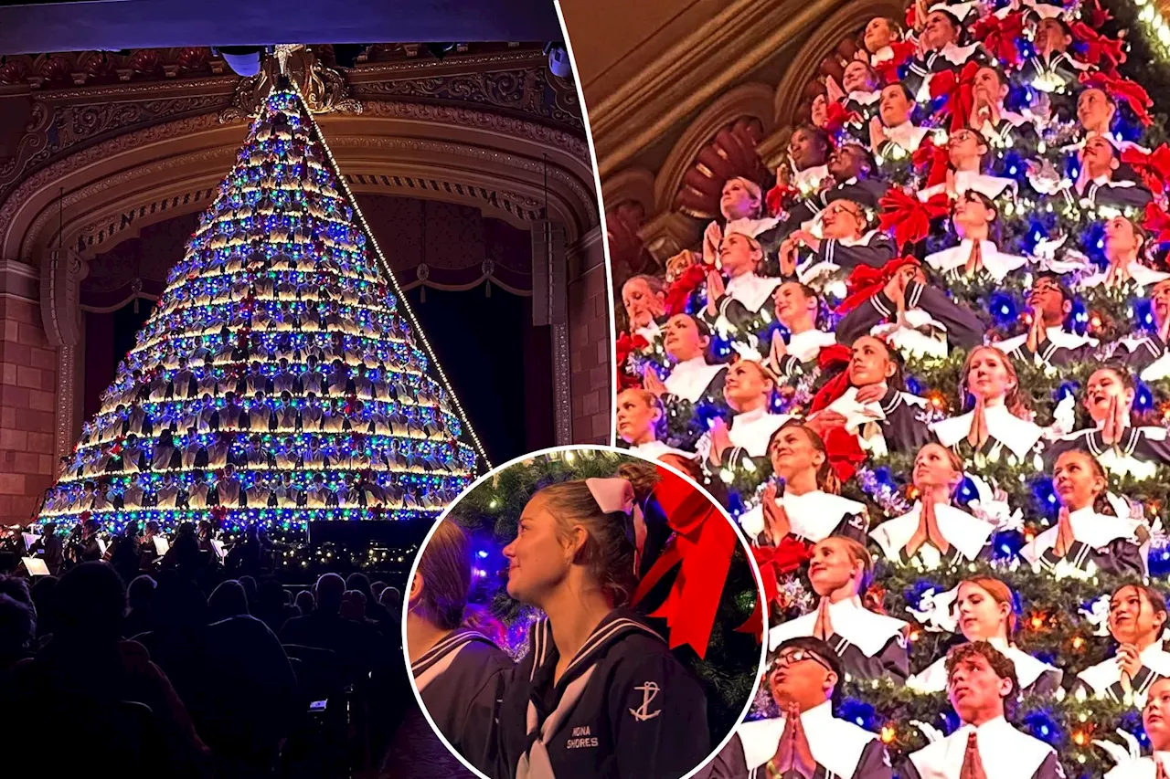 Michigan high school choir performs holiday concert from 67-foot-tall Christmas tree-shaped structure