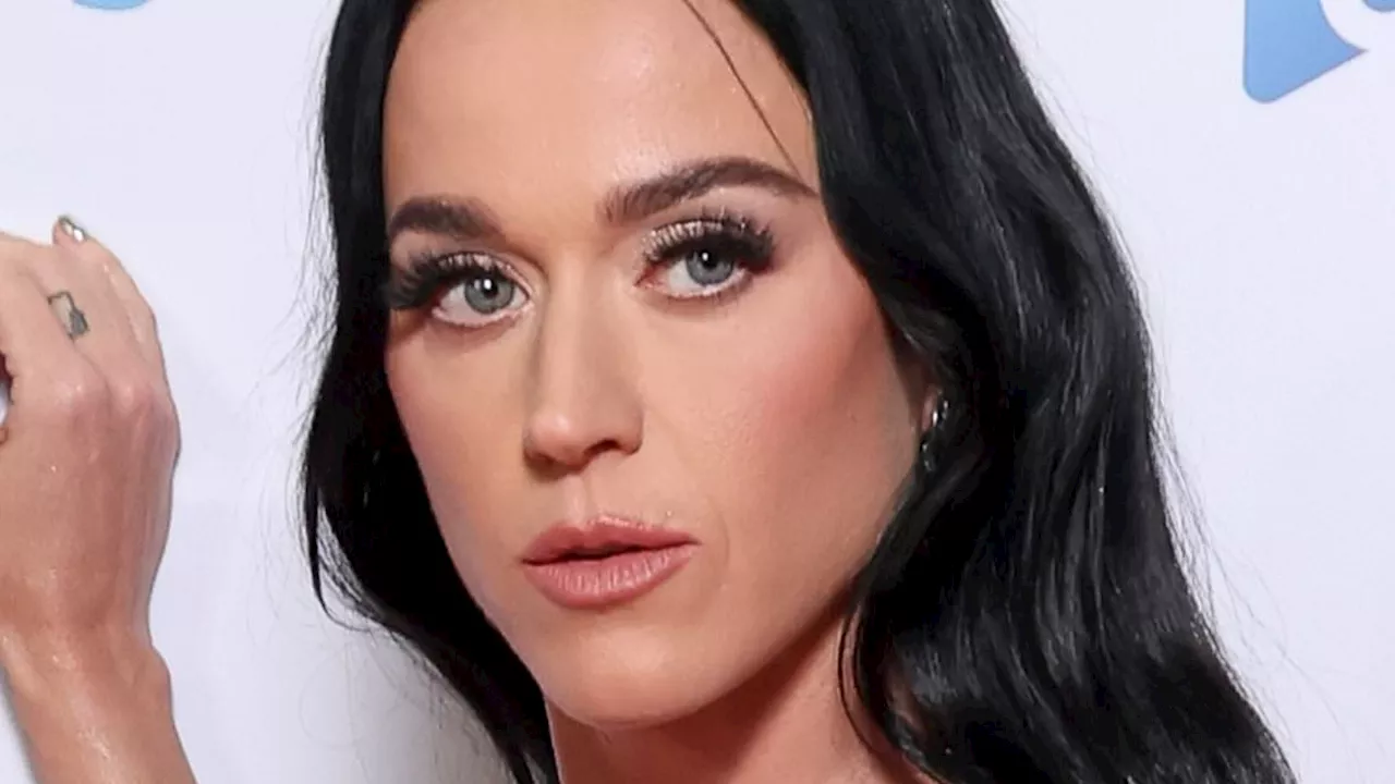 Braless Katy Perry wows in a daring silver gown as she poses on the Capital Jingle Bell Ball red...