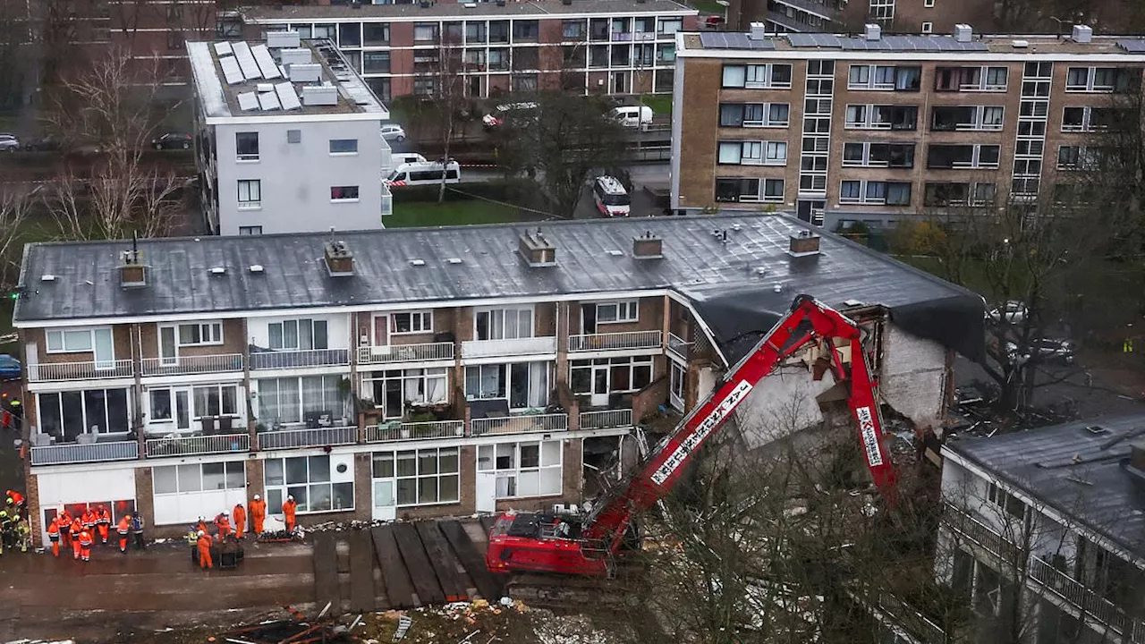 Police search for car that drove away from apartment block moments before devastating explosion...