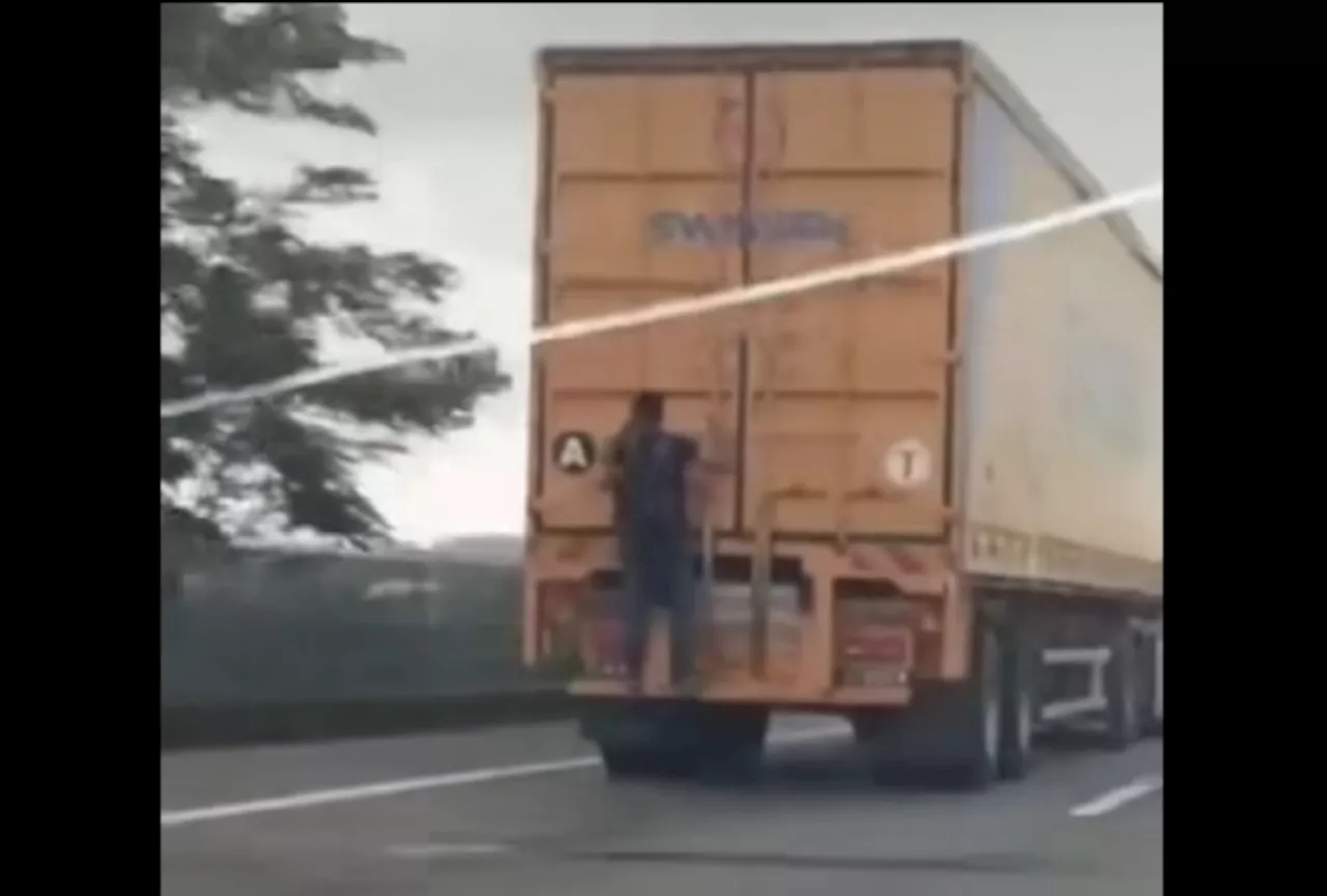 Johor police pursuing daredevil who hangs on to moving trailers on highway