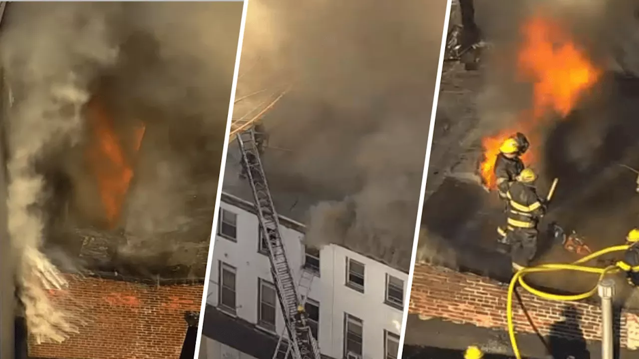 Residents have been evacuated as firefighters battle 2-alarm fire at two buildings in North Philly