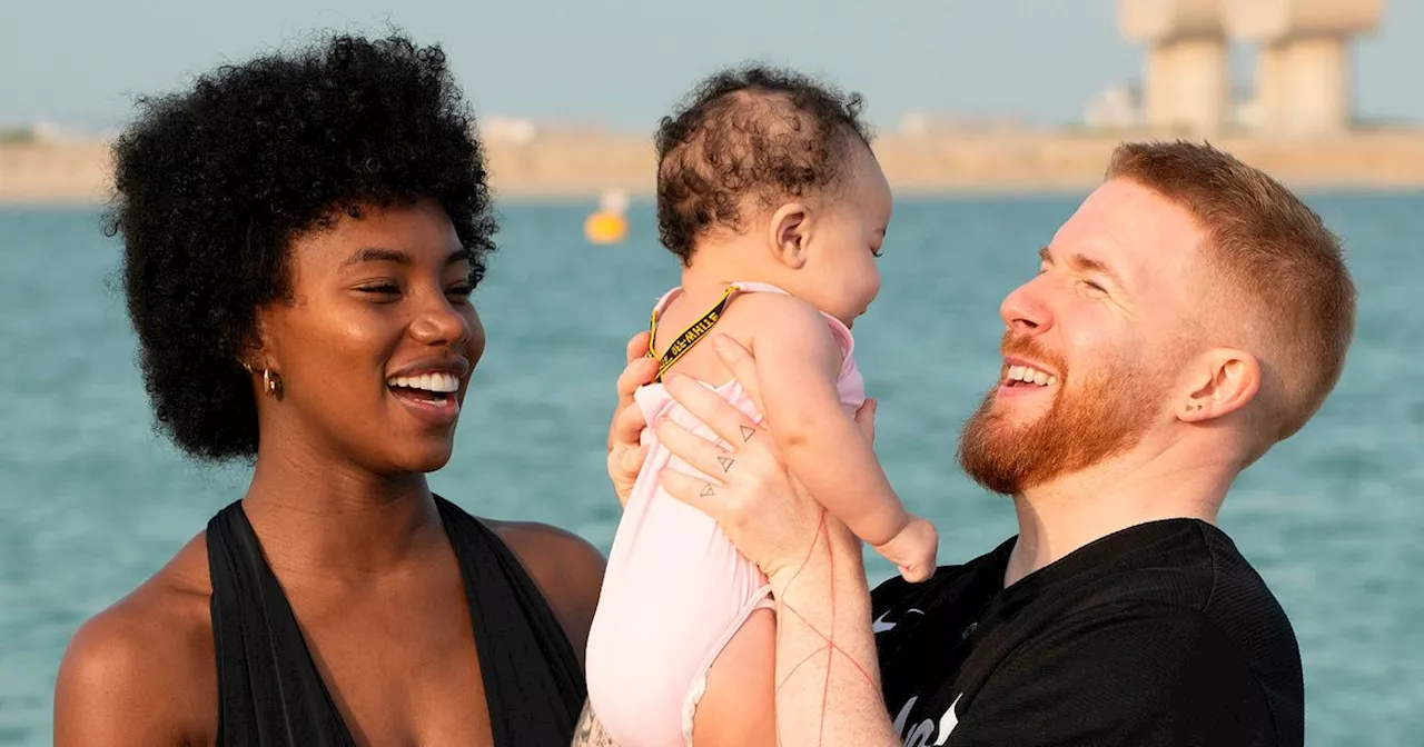 Neil Jones and Chyna Mills dote on baby Havana as they play on the beach