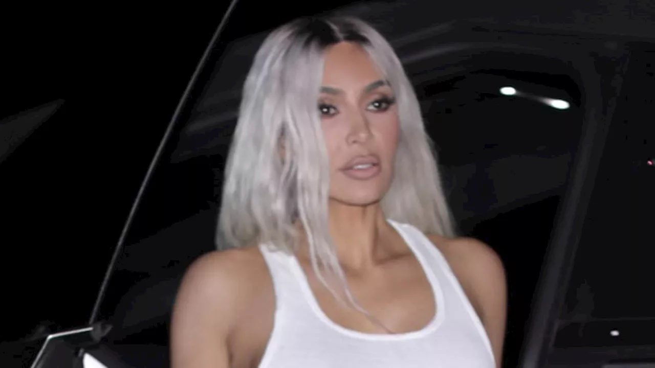 Kim Kardashian debuts new platinum blonde hair and shows off toned midriff in crop top and leather...