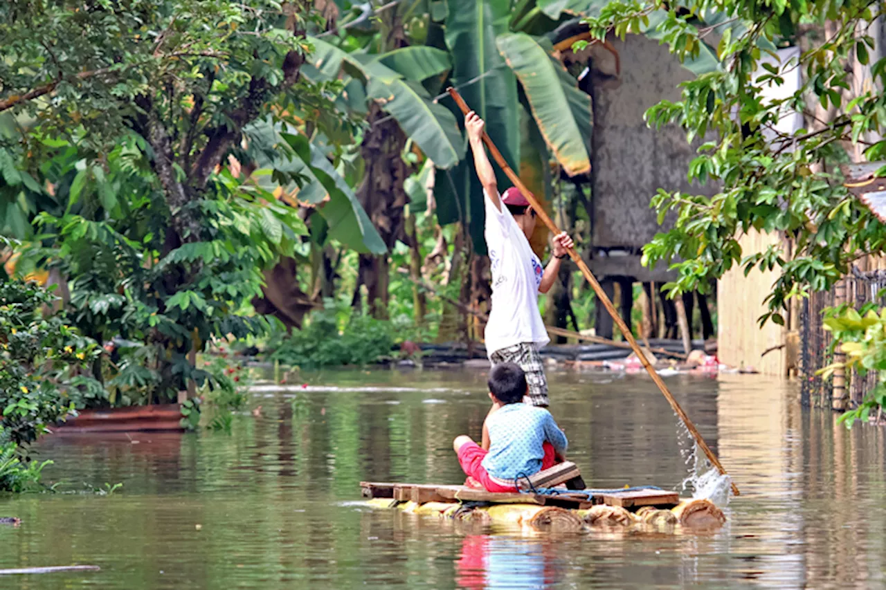 Children in Butuan City Use Makeshift Boat to Navigate Flooded Streets