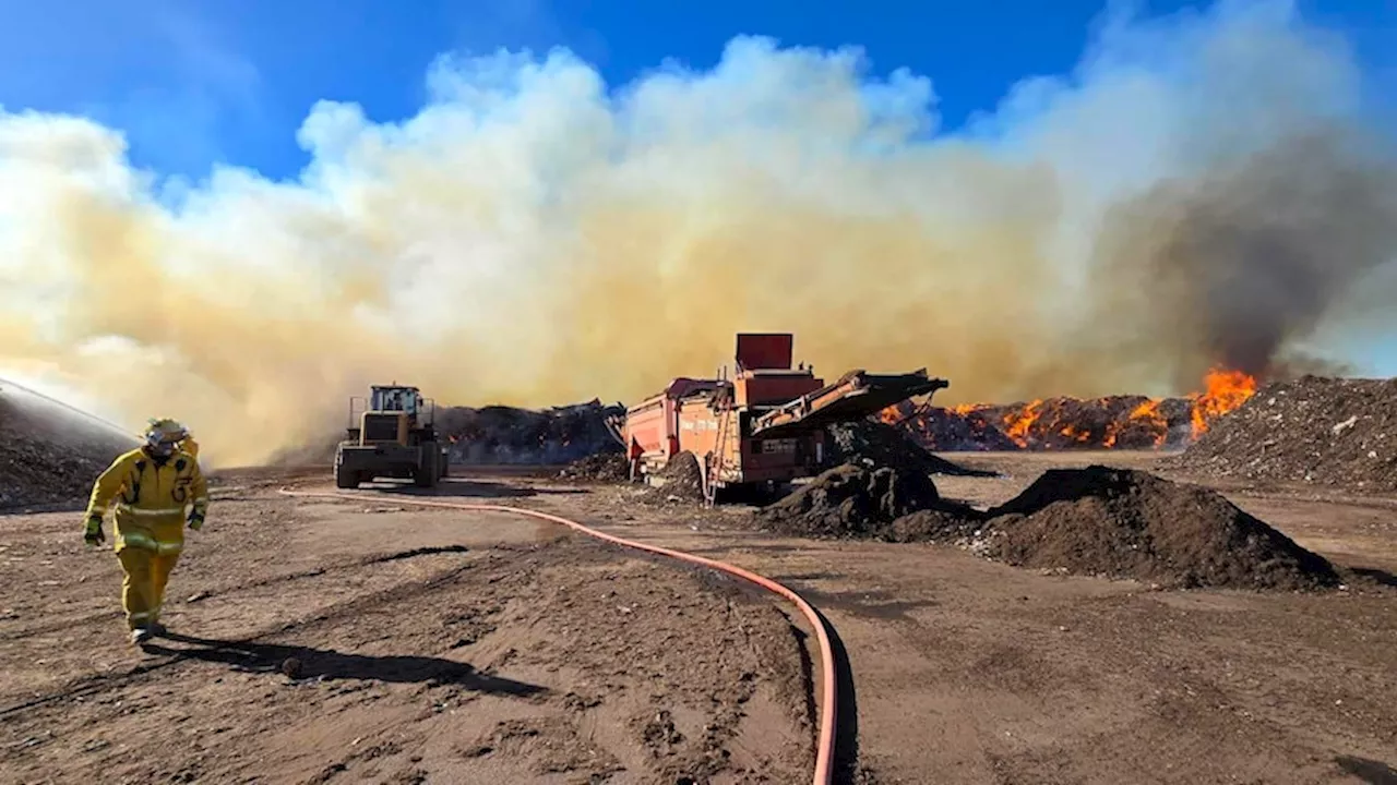 Fire rips through mulch facility as South Australia swelters through heatwave