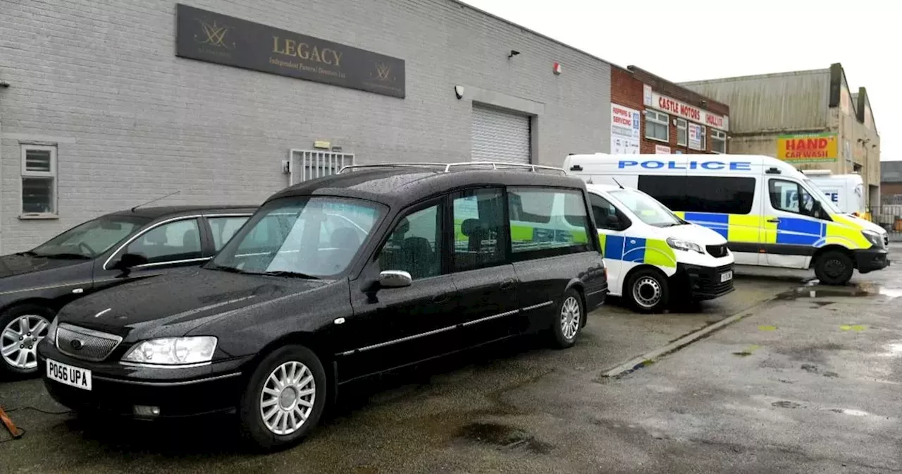 Man and woman arrested at funeral directors as 34 bodies moved by police