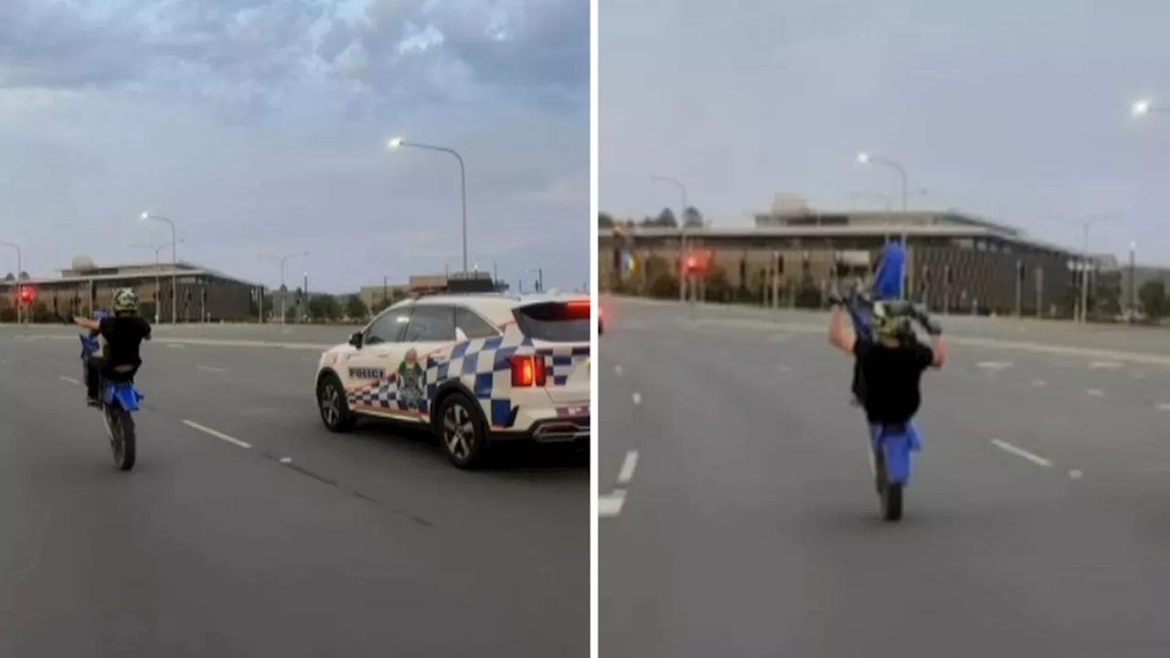 Motorbike rider filmed performing dangerous stunt in front of cop car on Sunshine Coast