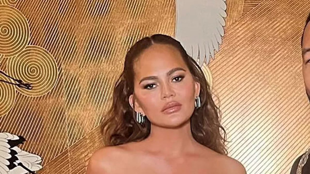 Chrissy Teigen refers to her 'boob lift scars' as she poses in racy sheer dress alongside husband...