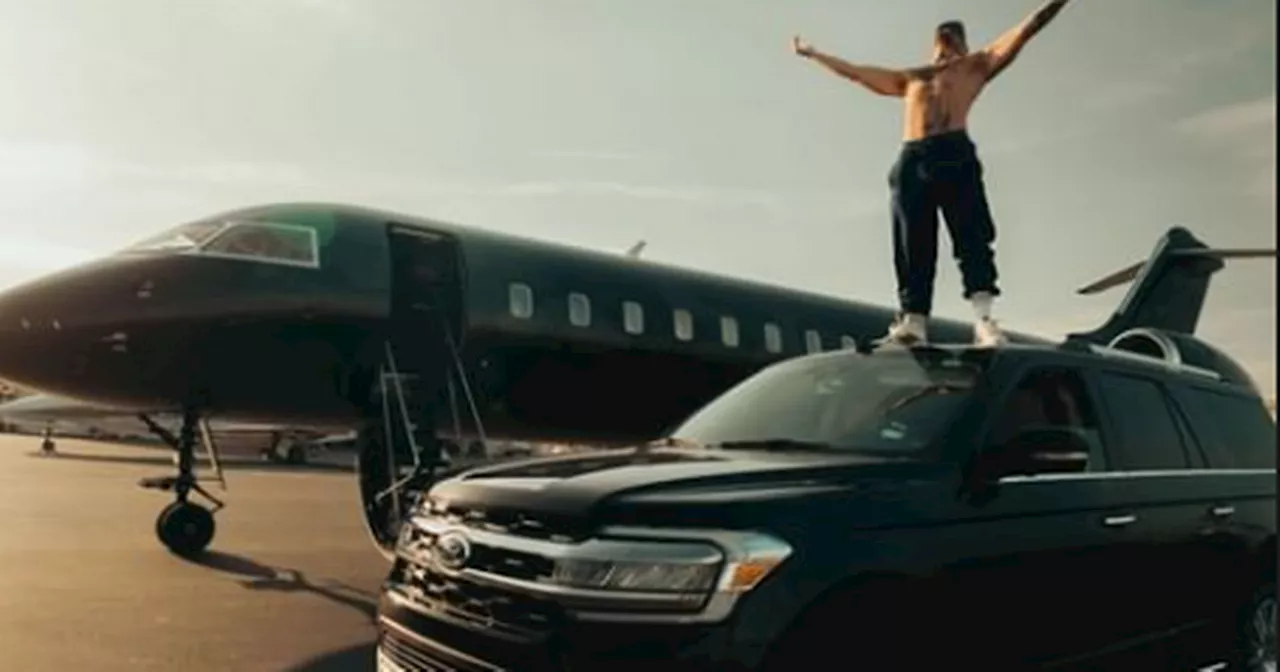 Conor McGregor climbs on top of car as he waits to board private jet