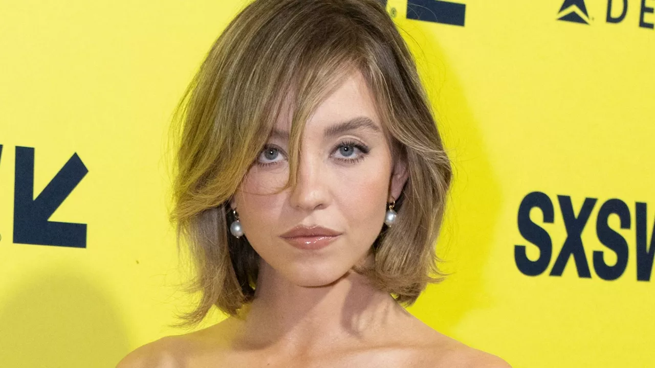 Sydney Sweeney stuns in sexy bridal dress with white lace stockings at film festival...