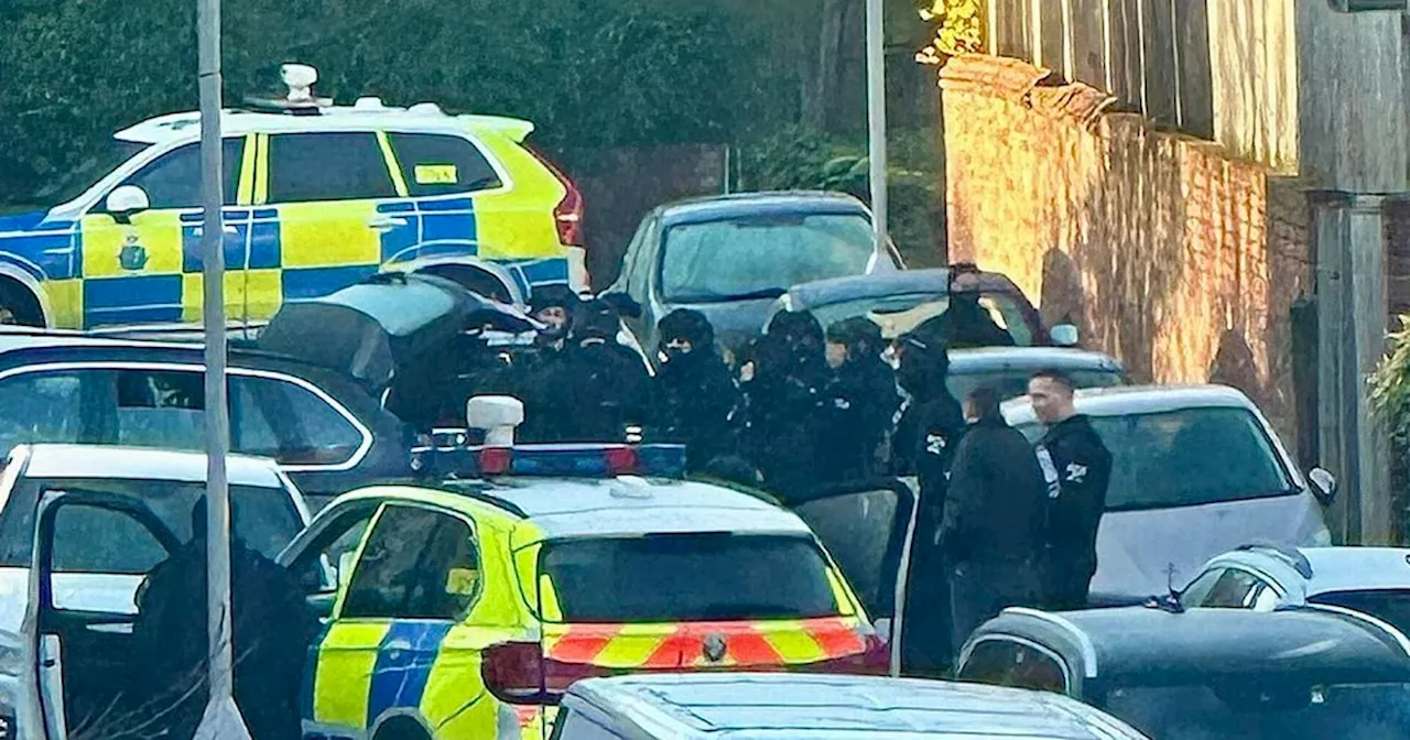 Live updates as armed police cordon off road