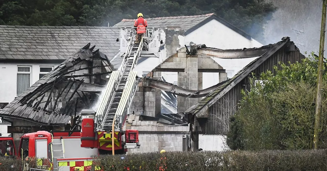 Building destroyed and residents evacuated as crews battle huge blaze