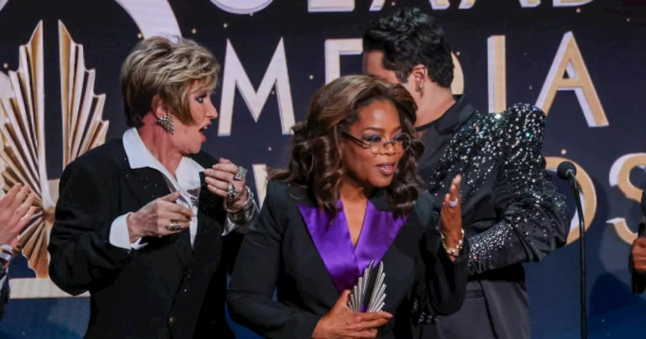 Woman takes huge tumble while handing Oprah Winfrey award on stage