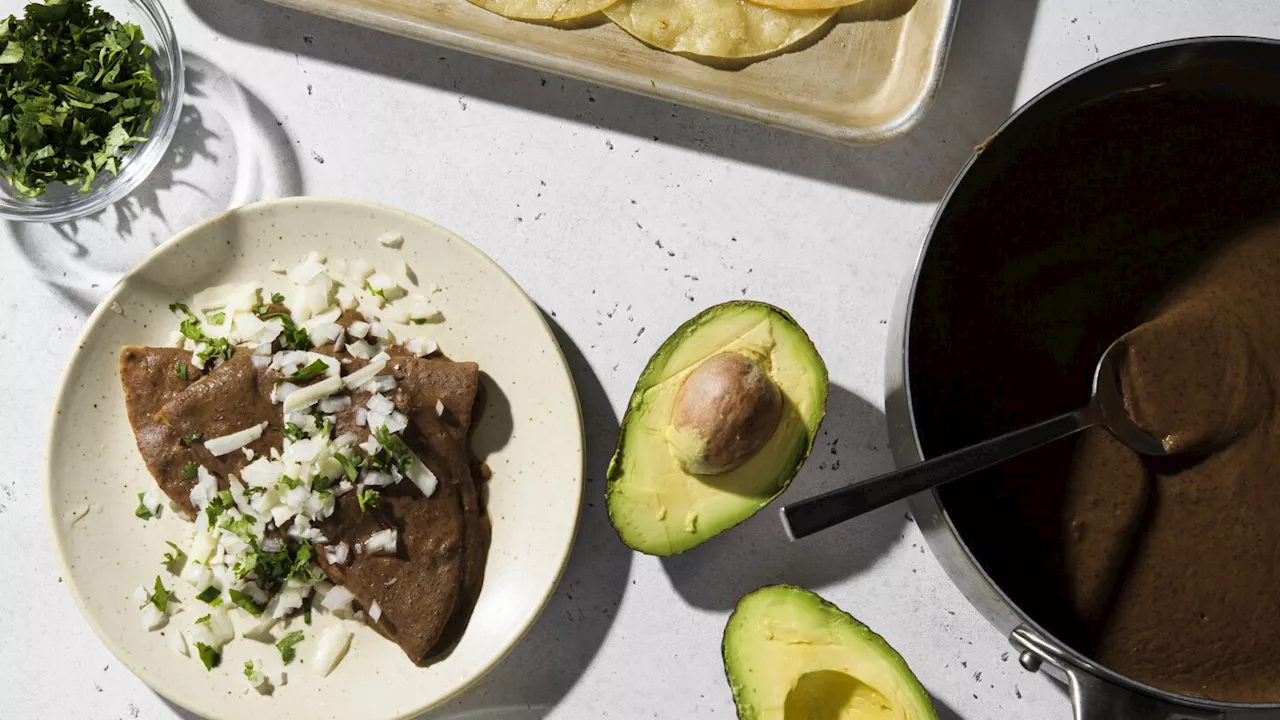 Turn a can of black beans into enfrijoladas, a saucy vegetarian supper