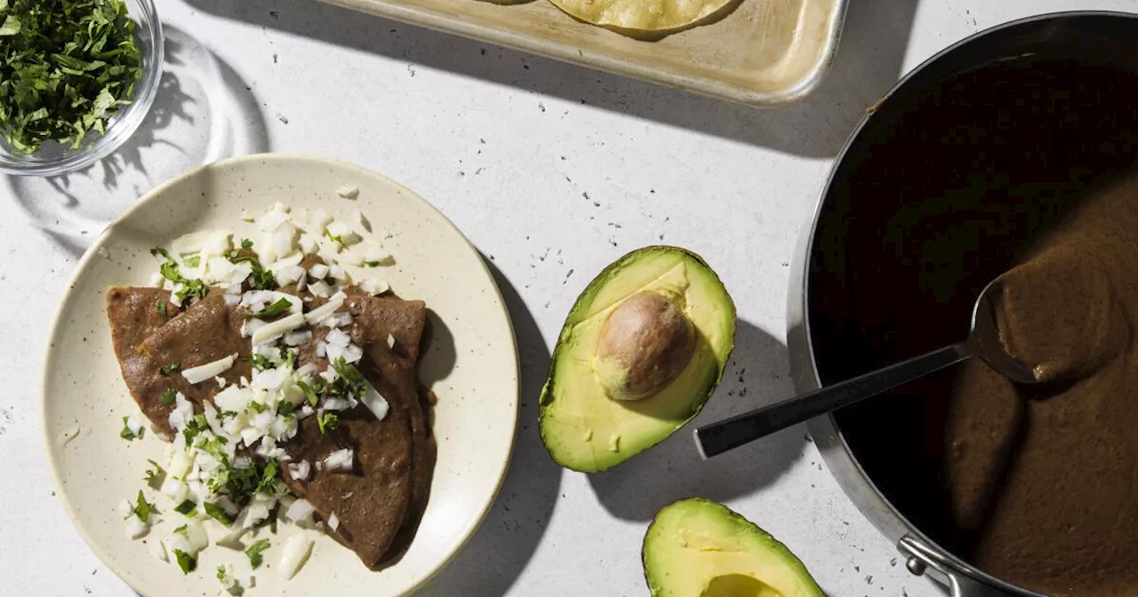 Turn a can of black beans into enfrijoladas, a saucy vegetarian supper