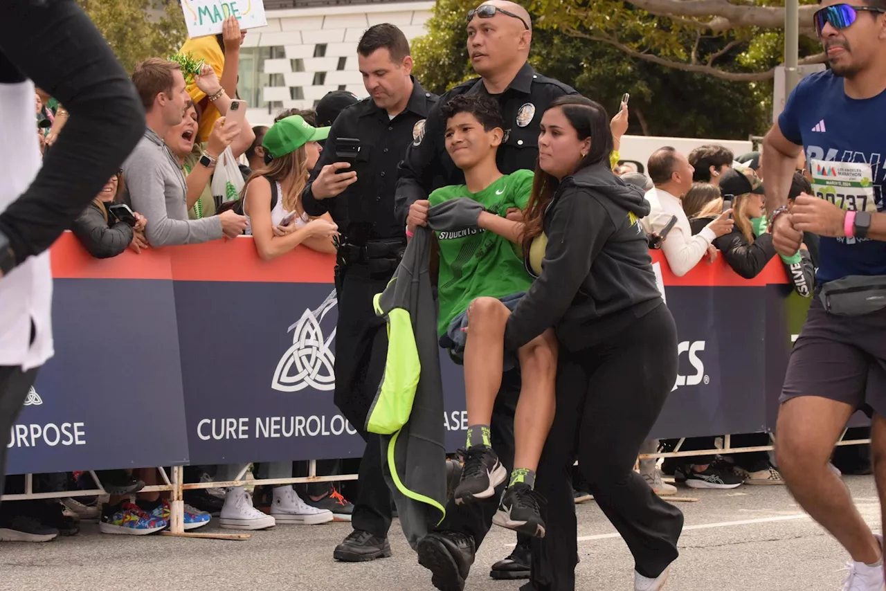 LAPD Sergeant helps determined eighth grader cross LA Marathon finish line