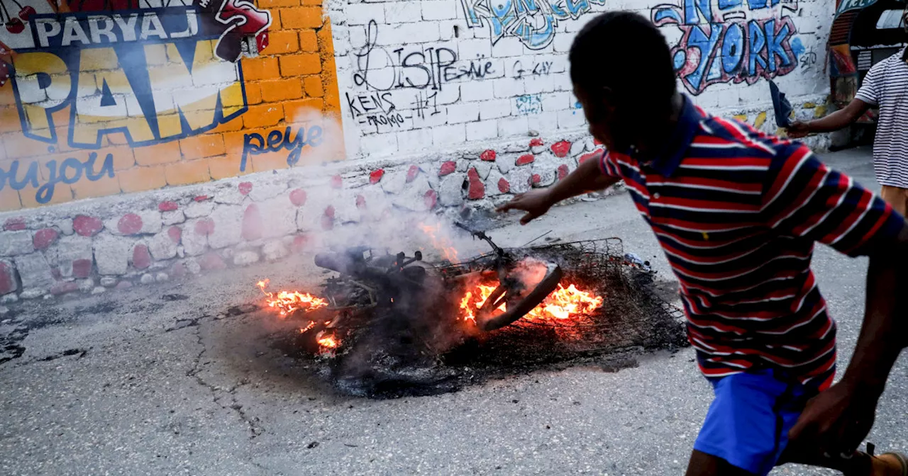 Haiti suspected gang members set on fire as conflict spreads to capital suburb