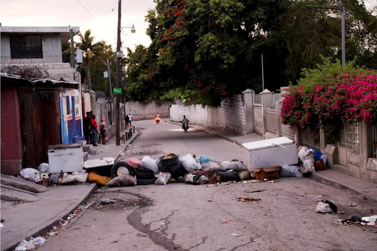 Suspected Haiti gang members set on fire as conflict spreads to capital suburb