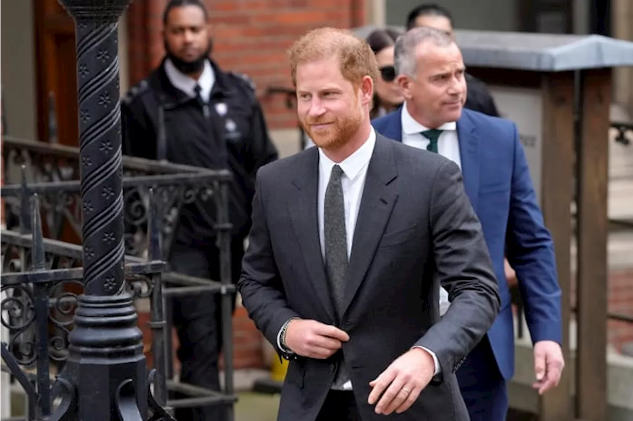 Prince Harry says tabloids intercepted phone calls of mother, the late Princess Diana, and father