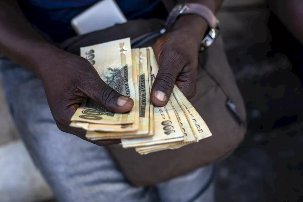 Battered Zimbabwe currency falls past 20 000 per dollar in official trade