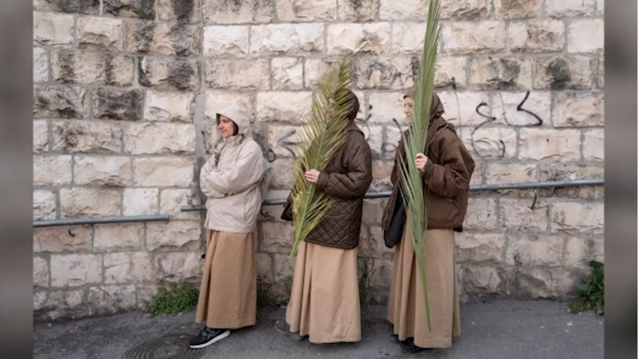 Thousands of faithful attend Palm Sunday celebrations in Jerusalem against a backdrop of war