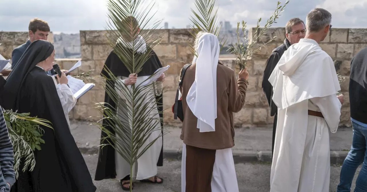 Thousands of faithful attend Palm Sunday celebrations in Jerusalem against a backdrop of war