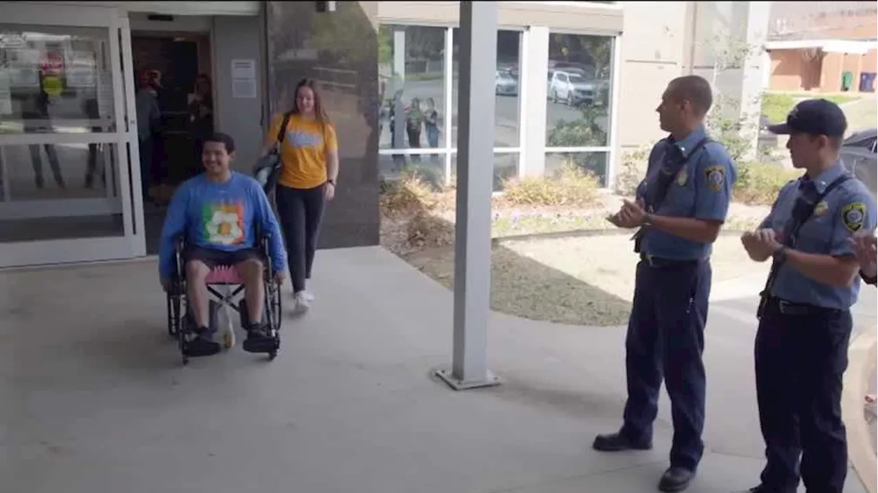 Volunteer firefighter injured in wildfires met with cheers as he leaves hospital