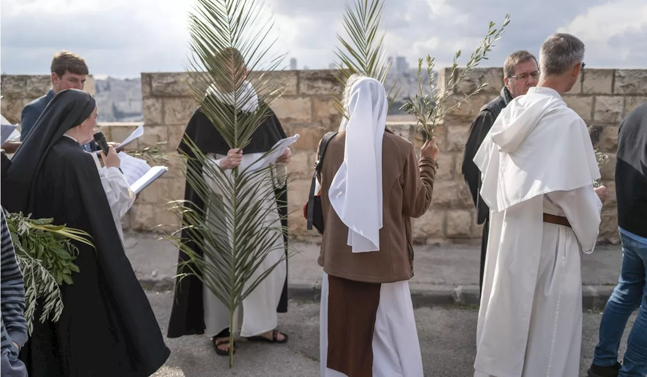 Christians attend Palm Sunday celebrations in Jerusalem against a backdrop of war