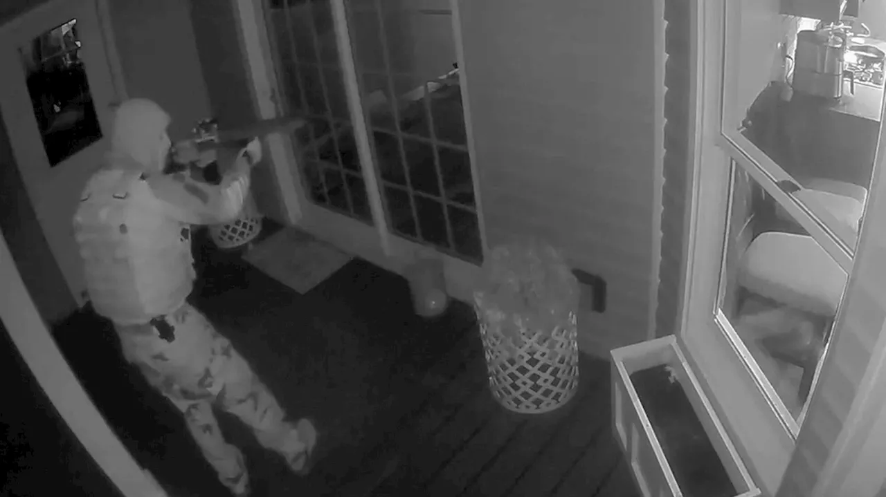 Chilling moment: Camouflaged man caught on camera pointing gun at North Carolina home