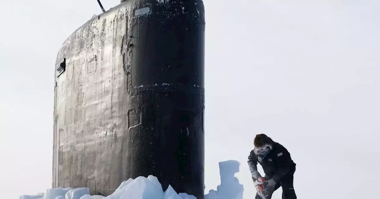 San Diego fast-attack submarine USS Hampton pokes through the ice in the Arctic Circle