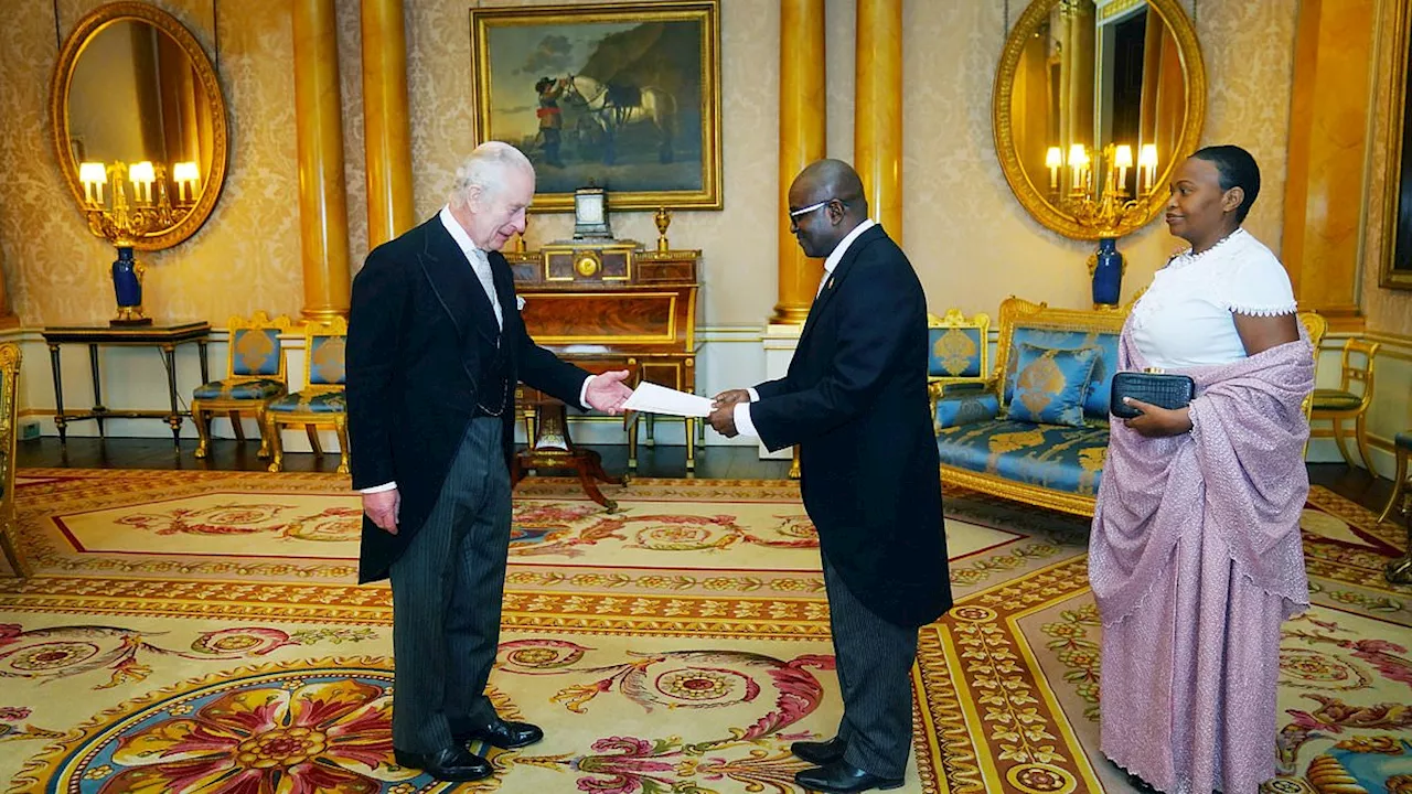 King Charles meets the ambassadors of Burundi and Moldova at Buckingham Palace as Camilla stands in...