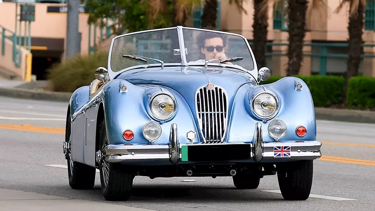 Brooklyn Beckham is spotted going for a cruise in LA driving a custom retro blue convertible Jaguar...