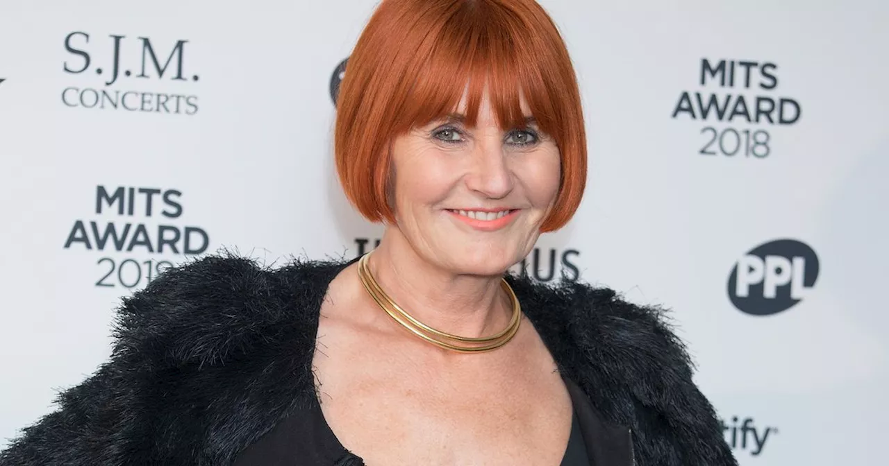 Mary Portas unrecognisable without signature red bob to collect OBE