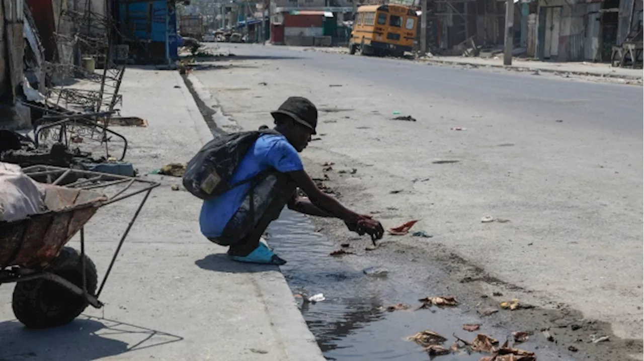 Police in Haiti say 2 men were hacked to death by a mob who thought they were buying ammo for gangs