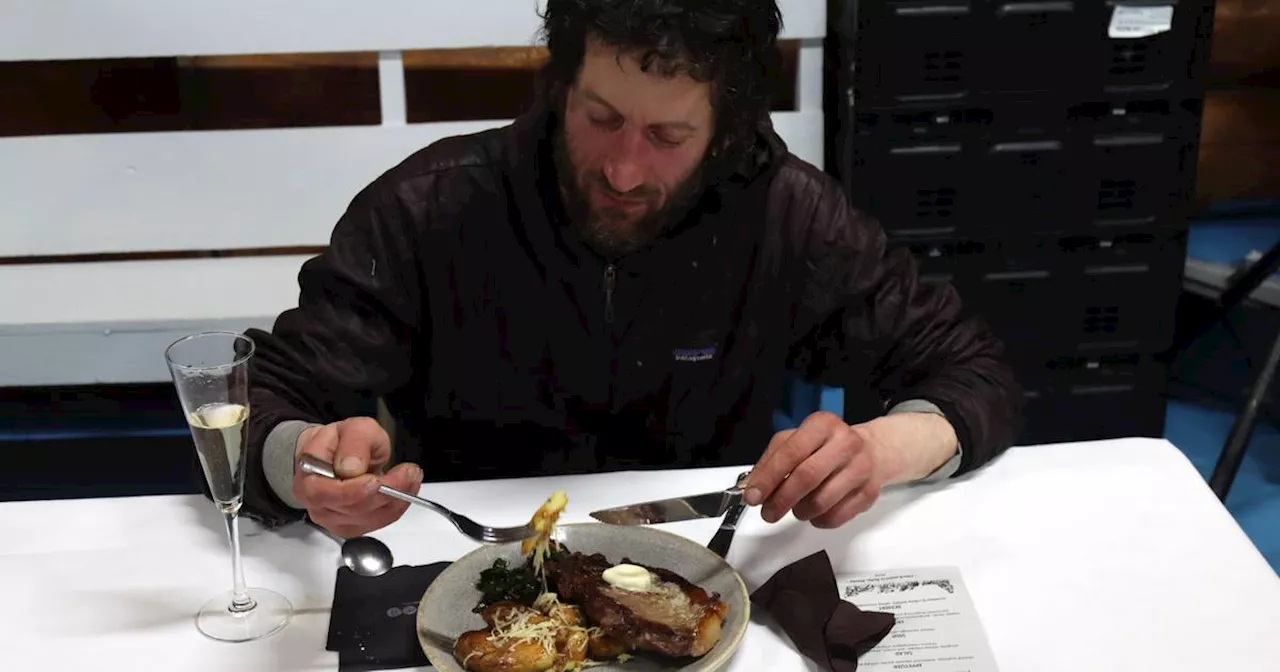 Iditarod musher Petit and his dogs chow down in Ruby after arriving first to the Yukon River town