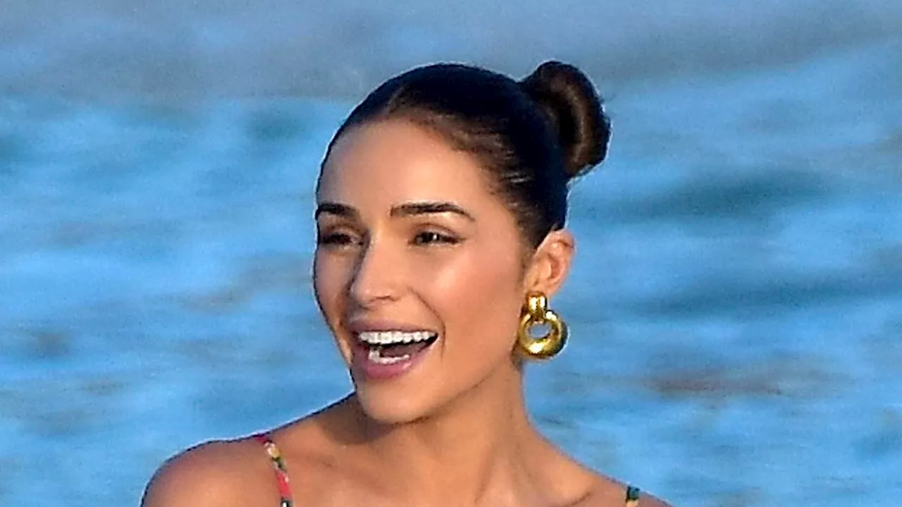 Olivia Culpo and Devon Windsor make jaws drop as they hit the beach in string bikinis during St...