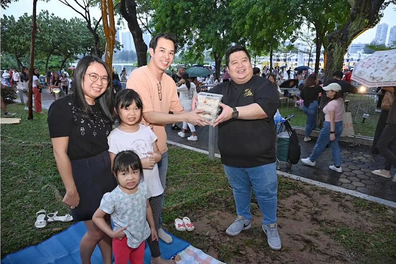 Swifties braving the rain at ‘Cat 100’ outside National Stadium treated to free chicken rice