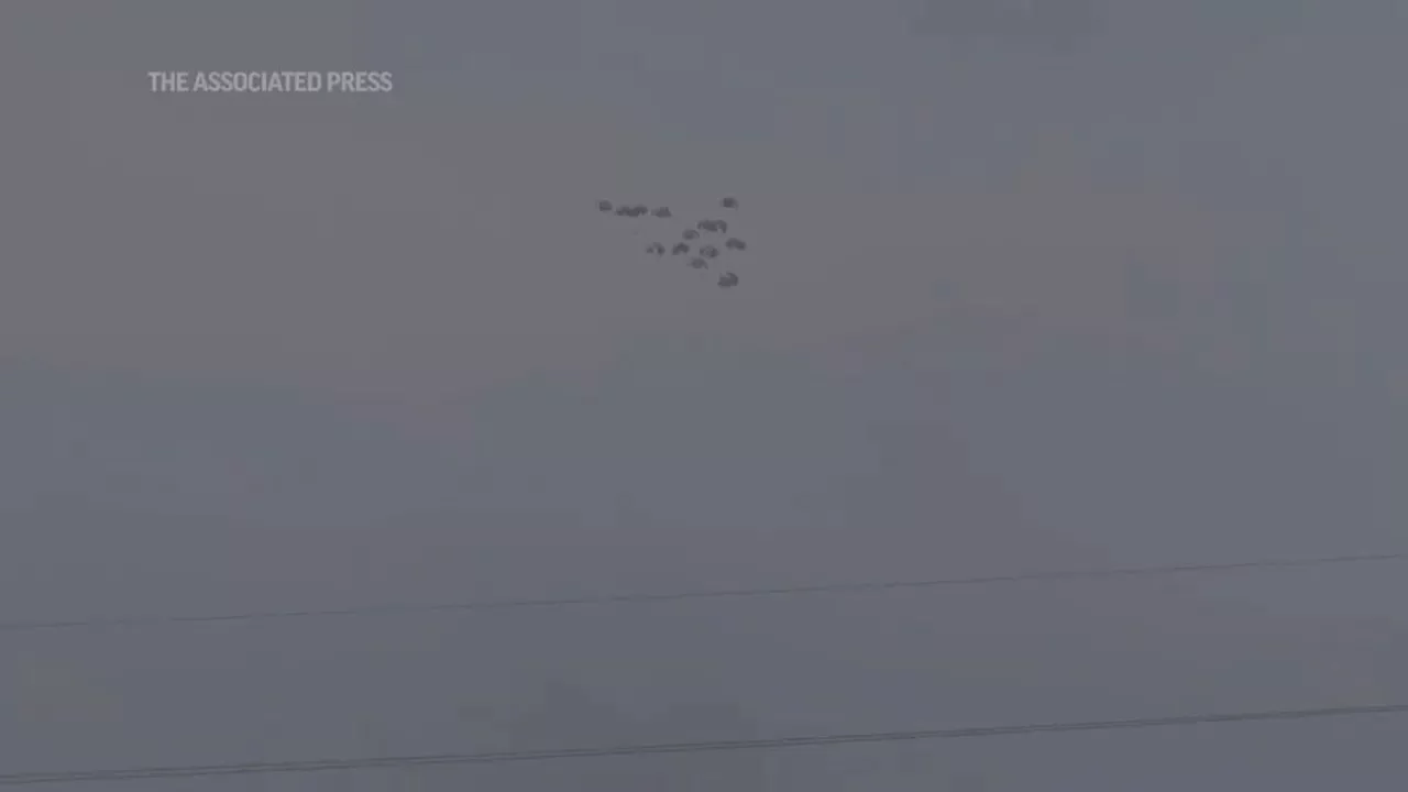 Parachutes delivering humanitarian supplies float down over Gaza Strip as air drops continue