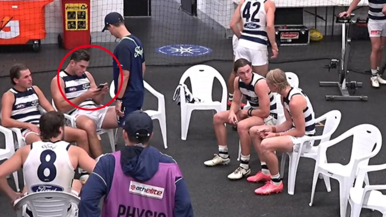 AFL investigating footage of Geelong champion Tom Hawkins looking at a phone during lightning delay